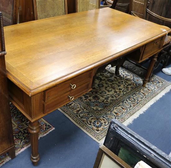 An early 20th century French oak writing table W.180cm